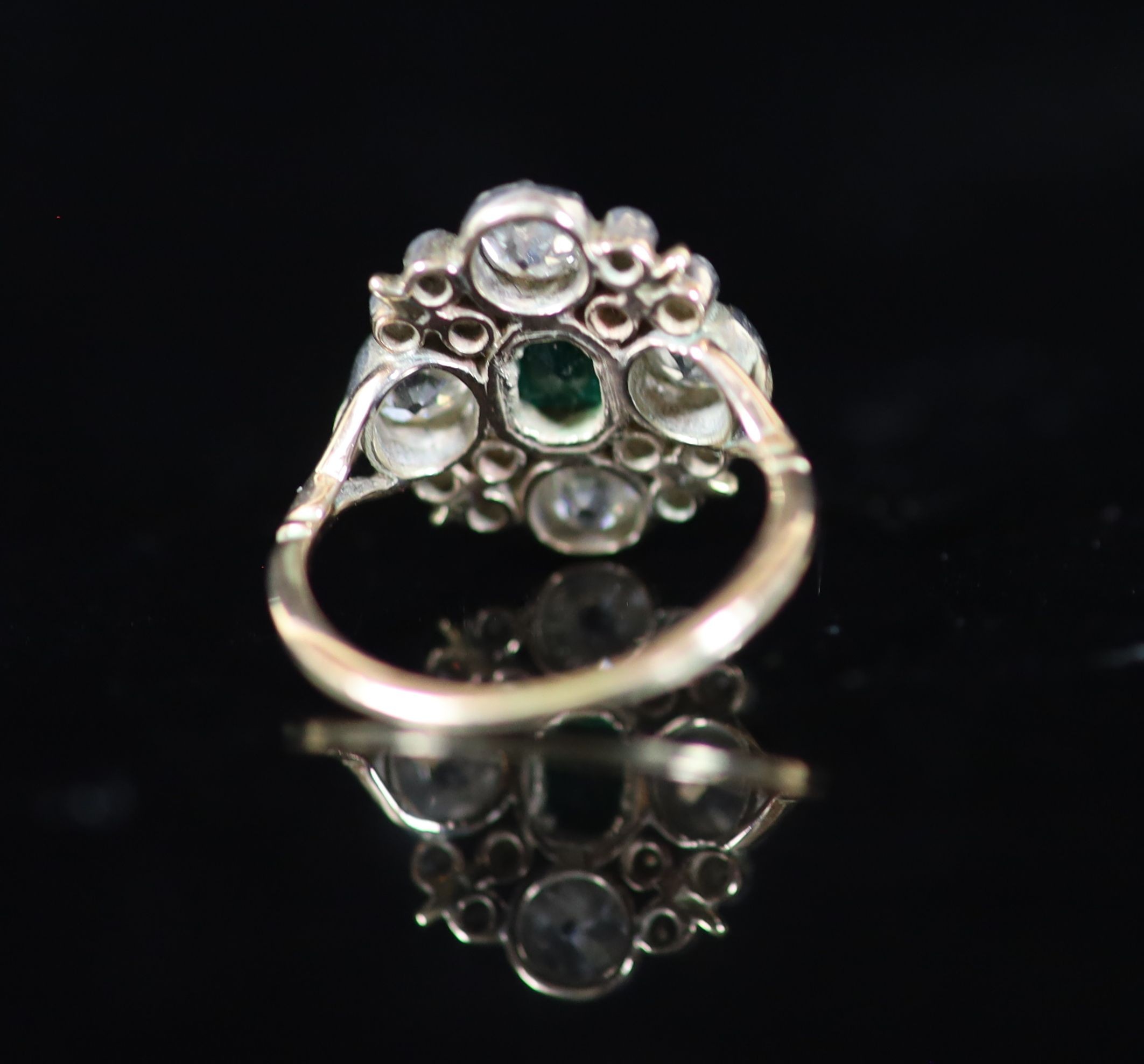 A 19th century gold and silver, emerald and diamond cluster dress ring